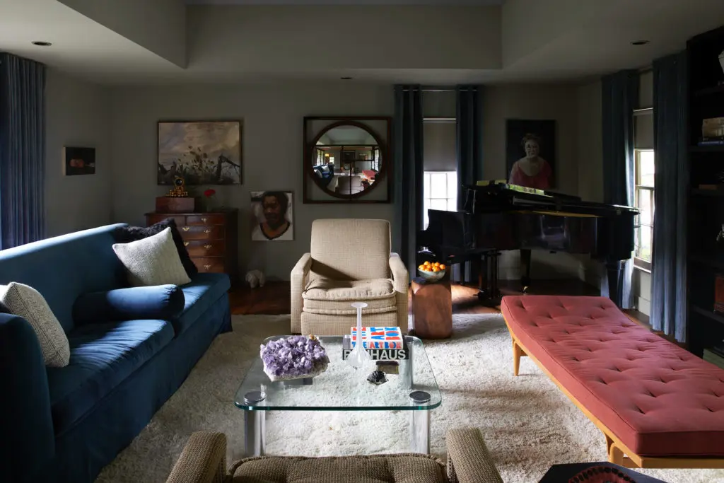 Bentley Tibbs and interior designer Kay Harris designed the main room's blue sofa and chairs. Bruno Mathsson 1950s daybed and 20th-century chrome table, both from Collage 20th Century Classics. Portrait by Dallas artist Riley Holloway and landscape by Mississippi artist Miles Cleveland Goodwin from Valley House Gallery. Painting at left by Sarah Williams from Talley Dunn Gallery. (Photo by Pär Bengtsson)