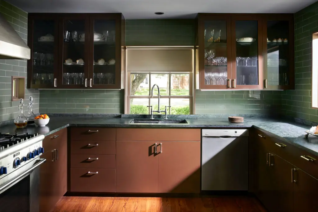 Bentley Tibbs designed the kitchen's cabinets, painted in Benjamin Moore Mink. Green glass tiles from Ann Sacks. Soapstone countertops. (Photo by Pär Bengtsson)