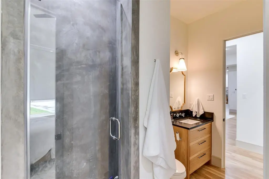 A concrete shower in the attached bath. 