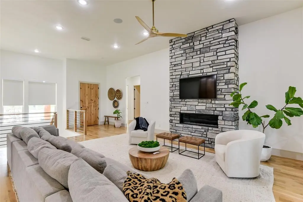 A wide open living room features a modern fireplace and plenty of room to spread out. 
