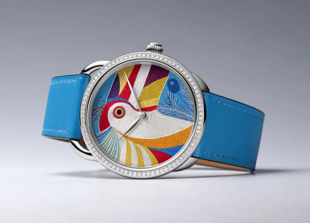 The limited edition Arceau Toucan de Paradis  timepiece, only 24 in production, by Hermès features a miniature enamel and silk thread toucan.