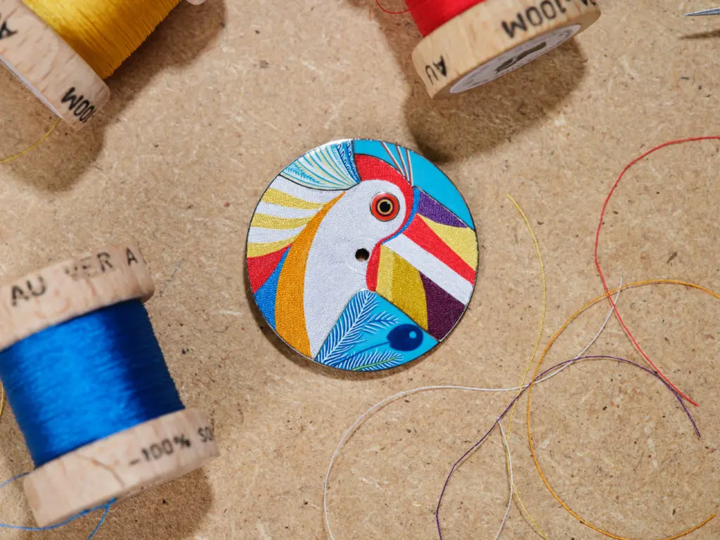 The Arceau Toucan de Paradis timepiece is composed of 500 silk threads, applied by hand in a week-long process. (Photo by David Marchon for Hermès)

