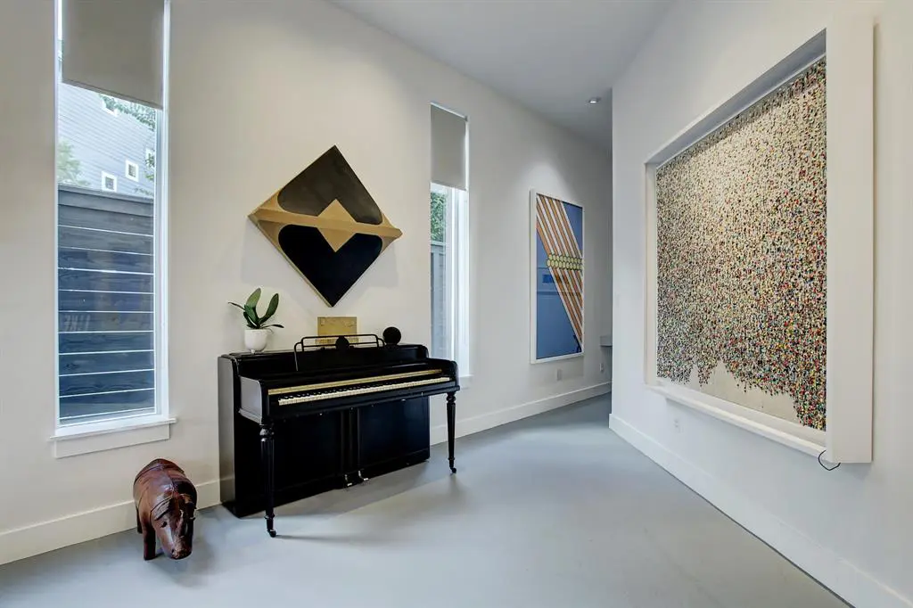Wide wall spaces leading to the powder room create a gallery-like feel. 