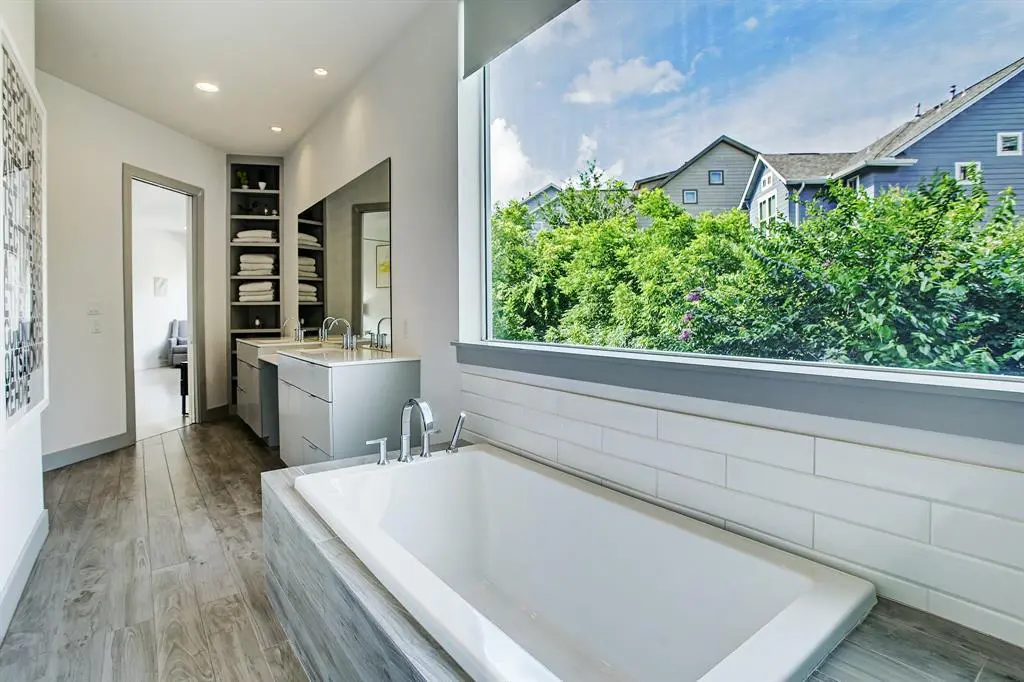 A soaking tub, shower and double sinks in the master bath at the Triangle House in The Heights.