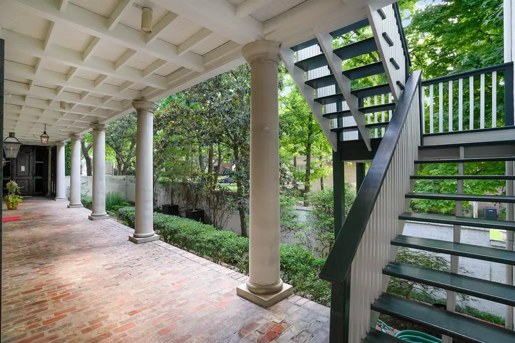 A main entrance located along the side of the home, and a separate stairwell for the spare bedroom. 