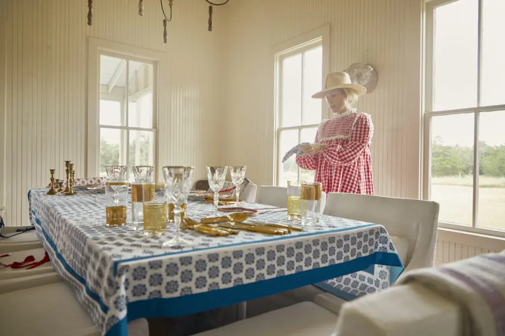 Designer Hunter Bell arranges the tabletop featuring her new line of Texas country-inspired linens.