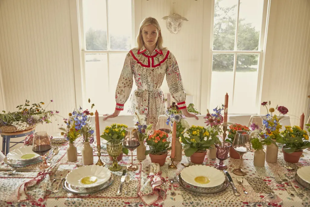 Fashion designer Hunter Bell introduces her table linens collection, which will be available beginning September 3. Pictured here, the patchwork table linens echo the patterns in the model's Jasper dress from the Hunter Bell portfolio.