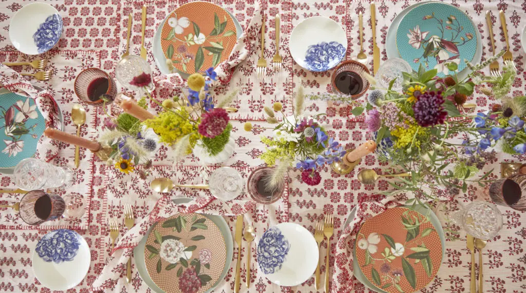 The table is set with Hunter Bell's Western Willow Red linens.