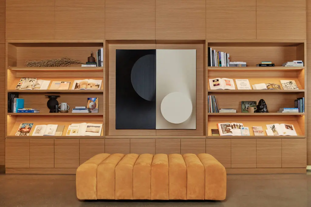 On the shelves, art and culture books from Forty Five Ten and pottery by Carrie White and Matthew Gilley. Painting from Sputnik Modern. Custom ottoman. (Photo by Max Kutz)