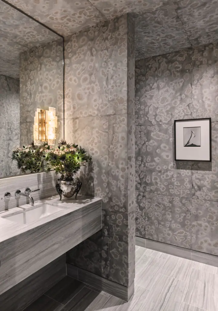 In a powder bath, Carolyn Ray's "Spotted Glaze" painting on rice paper and mulberry sheets covers walls. Pagani Studio sconce. Calla photograph by Imogen Cunningham. (Photo by Douglas Friedman)