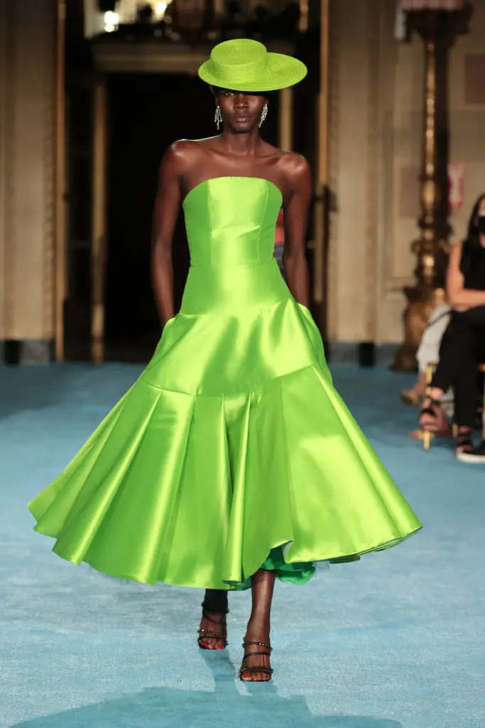 Christian Siriano green satin dress and hat evoke his idea of holiday life in Positano. (Photo courtesy of  (Photo by Mike Coppola/Getty Images for Christian Siriano)