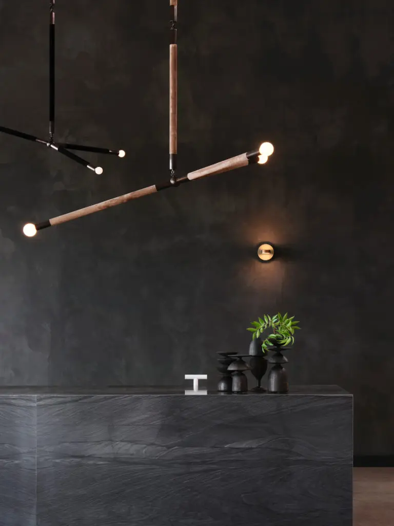 Apparatus Studio Arrow pendants, NY.
Custom stone desk and ceramics by
Jeffrey Loura, NY. (Photo by Lisa Petrole)