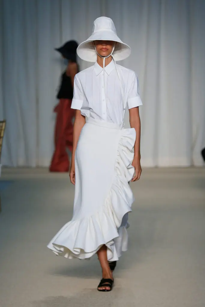 Adam Lippes white laser cut poplin top, ivory linen ruffle skirt, ivory linen hat. (Photo courtesy of Adam Lippes)