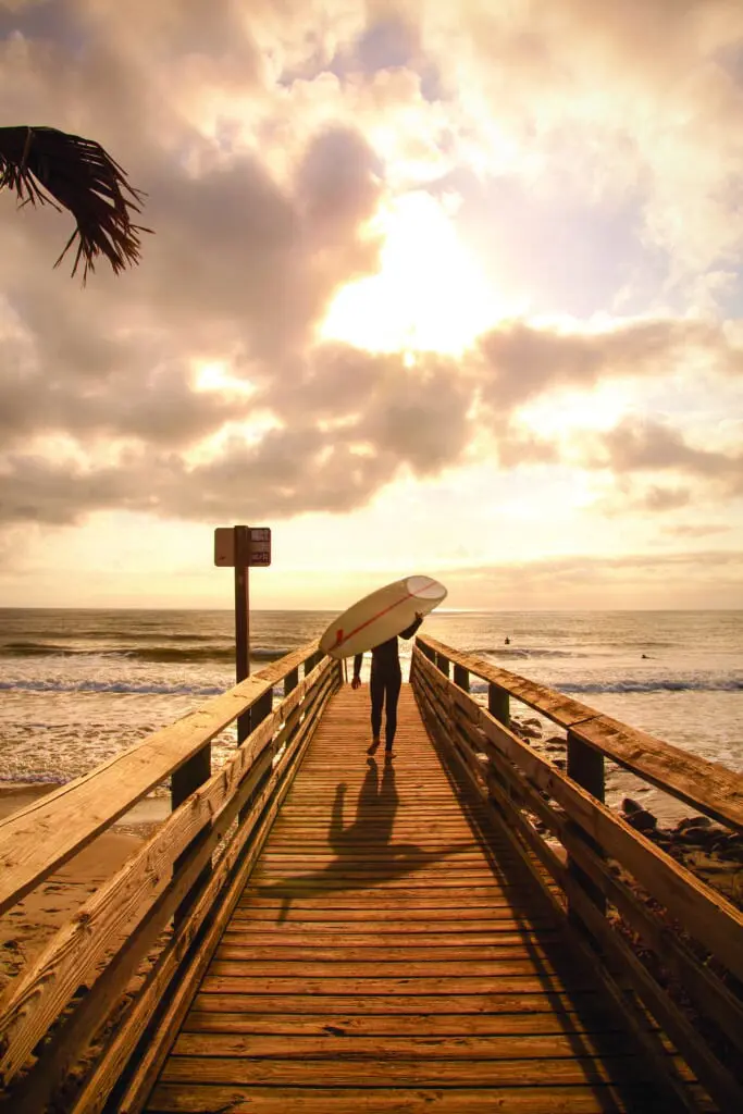A surfer sets out to ride a wave on Folly Beach. (Photo Doug Hickok)