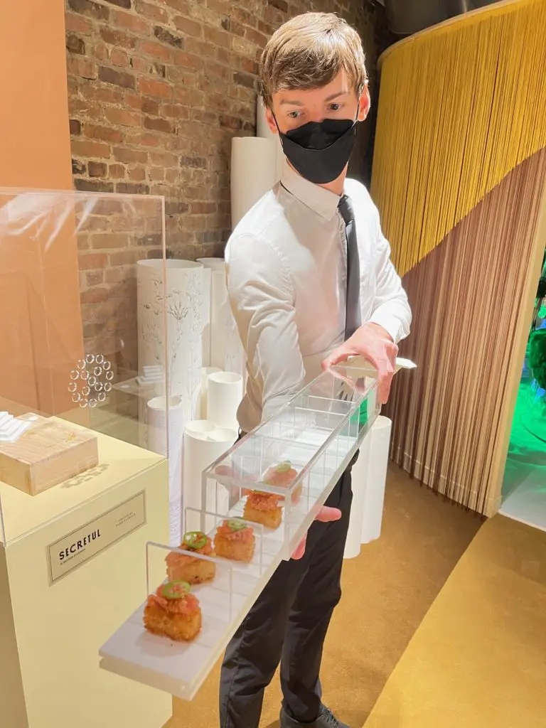 Waiters passed hors d'ouevres, each encased in a separate plexiglass container. (Photo by Clifford Pugh)