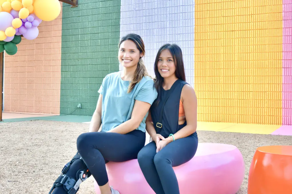 Kim Aing, Lisa Nguyen at unveiling of the Sugar & Cloth Color Wall.  (Photo by Alex Montoya)