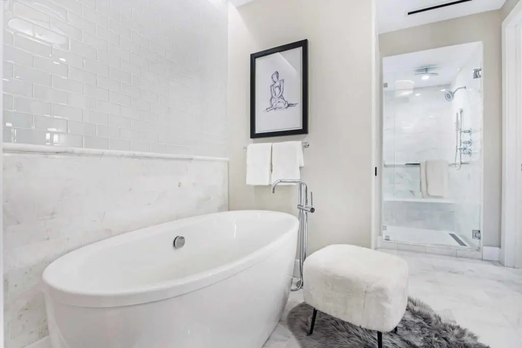 Relax and refresh in the well-appointed master bathroom featuring Kohler soaking tubs and spa-like zero-threshold frameless glass showers complete with rain shower heads, hand held body sprays, and benches. 