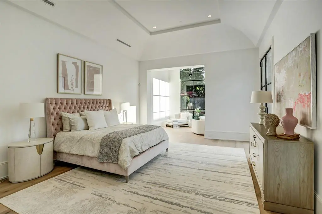 The primary bedroom features a 14-foot vaulted ceiling and separate sitting area. (Photo by TK Images)