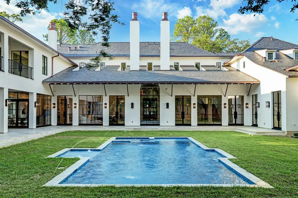 The in-ground swimming pool and spa provide a dramatic viewpoint to the back of the 12,095 square foot River Oaks mansion. (Photo by TK Images)