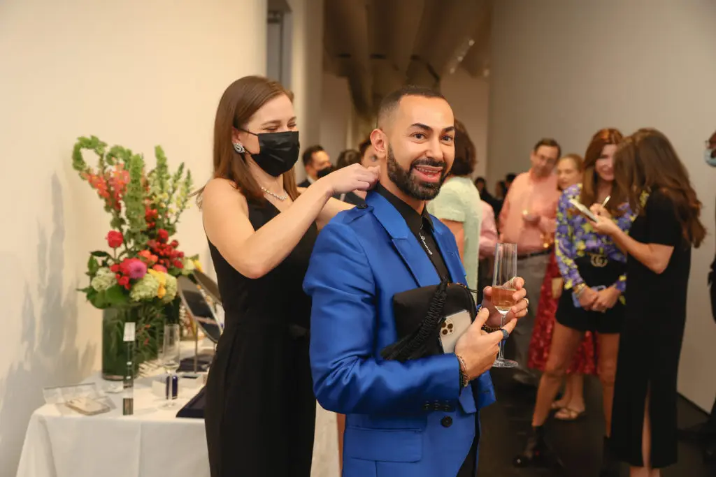 Fady Armanious trying on diamonds at the De Beers Jewellers celebration of its Reflections of Nature collection at The Menil Collection. (Photo by Johnny Than)