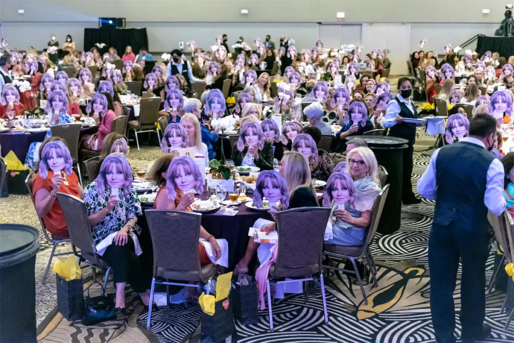 Guests of Chick Lit Luncheon holding up their Goldie Hawn faces. (Photo by Tamytha Cameron, Celeste Cass and Melissa Macatee)