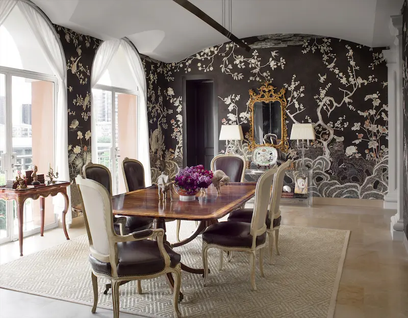 Dining-room wallpaper is de Gournay's Coco Coromandel. Antique Baccarat candlestick lamps were purchased in New Orleans, an anniversary gift from the homeowner's father to her mother. the table is 18th-century English Georgian, and the chairs, 19th-century French. (Photo: Emily Minton Redfield)