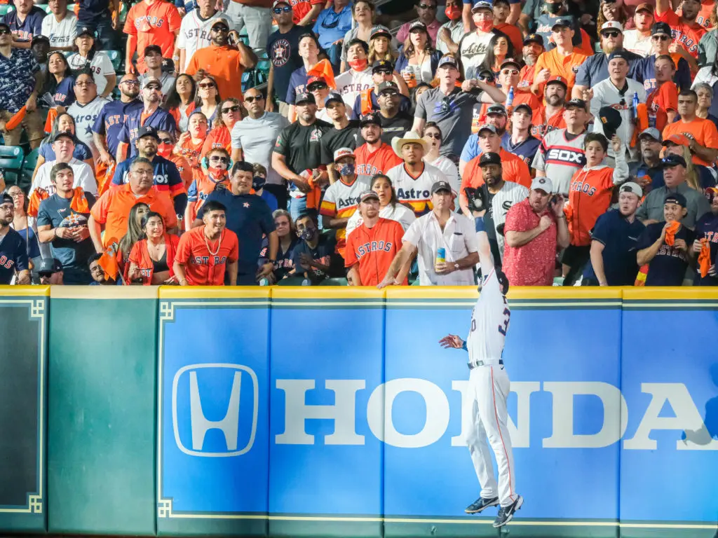 Kyle Tucker went high to catch a fly ball near the wall. (Photo by F. Carter Smith)