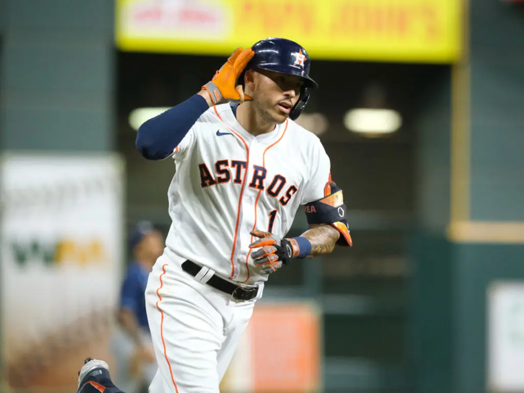 Carlos Correa lifted little Anaiah Maldonado up high in the sweetest Astros celebration yet last October. (Photo by F. Carter Smith)