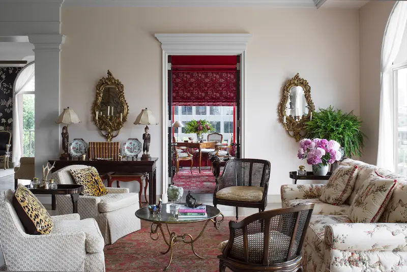 The client wanted to recreate a red-lacquer library from her previous house, so Fusch walled in a corner of the living room for this purpose and added a classical pediment over the doorway for architectural interest. (Photo: Emily Minton Redfield)