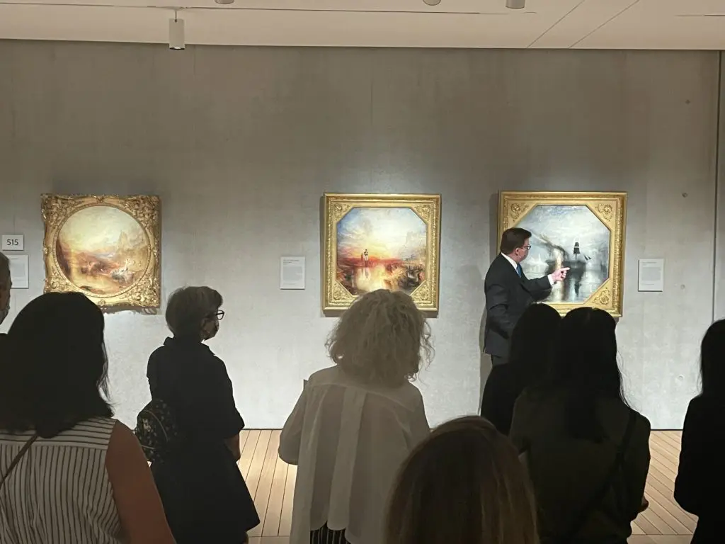 Curator George T.M. Shackelford discusses the final pair of paintings in the exhibit depicting War and Peace. Photo by Courtney Dabney.