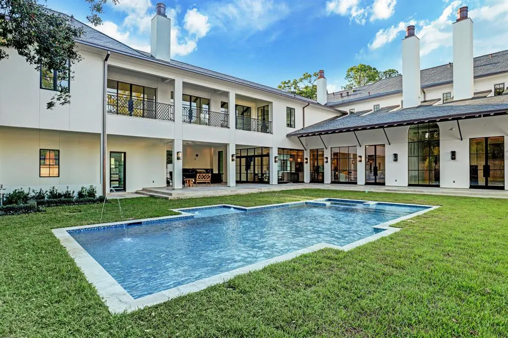 The in-ground swimming pool and spa provide a dramatic viewpoint to the back of the 12,095 square foot River Oaks mansion. (Photo by TK Images)