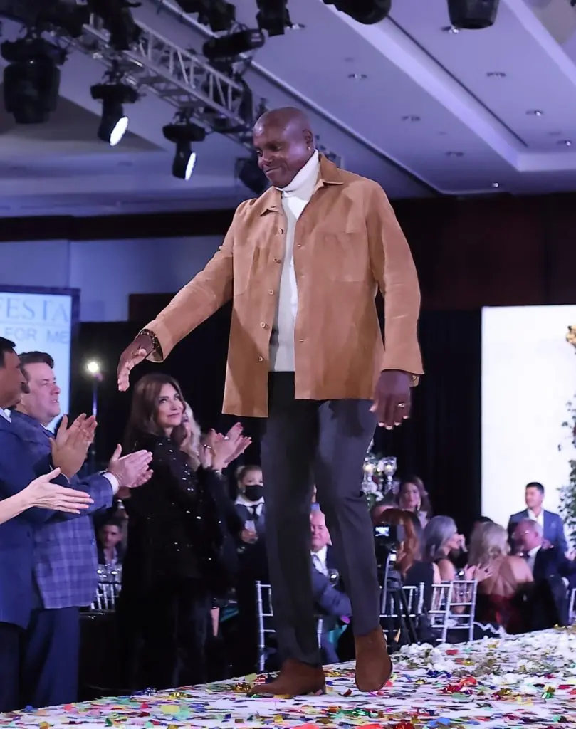 Olympian Carl Lewis receives a standing ovation as he strides the catwalk at Una Notte in Italia (Photo by Quy Tran)