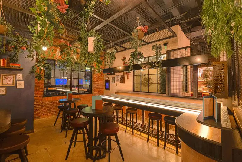 Electric Shuffle consists of two floors, two bars, and 17 shuffleboards.