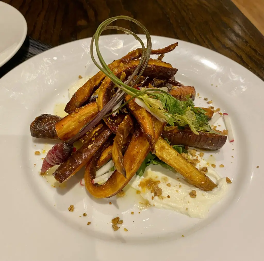 The roasted rainbow carrot salad with whipped ricotta and pistachio brittle might as well be a dessert at Beckley 1115. (Photo by Megan Ziots)