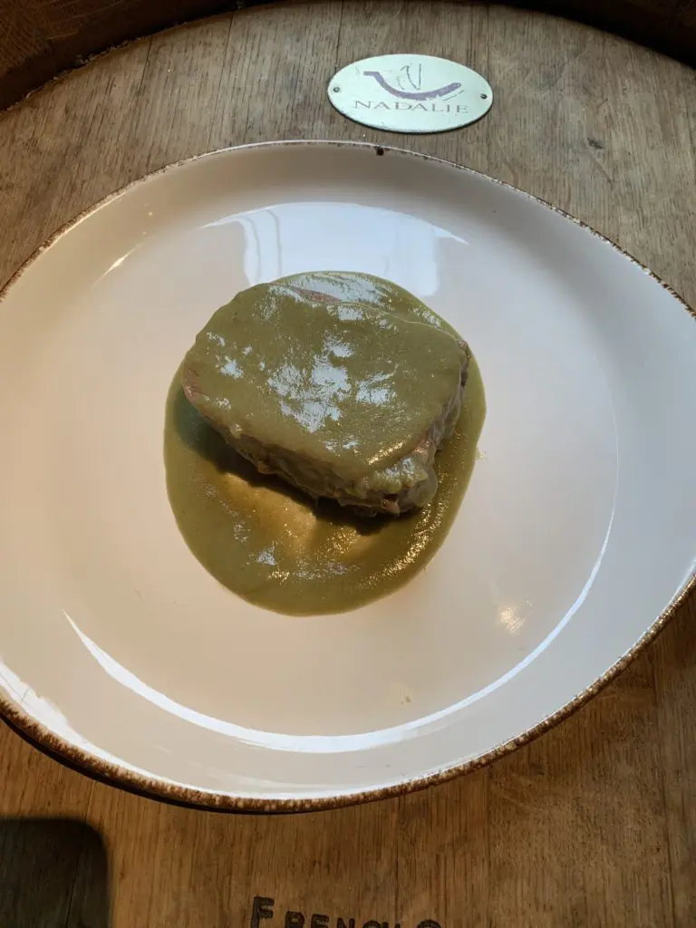 This is a fresh green Mole Verde with grilled Chicken. the green mole is one of the famous seven moles of Oaxaca. The sauce is usually thick and is made with tomato, chile de agua or serrano, garlic, cloves, pepper, parsley, coriander, epazote, holy grass and corn dough; sometimes includes chopped vegetables like green beans and chayotes. (Photo by Laurann Claridge)