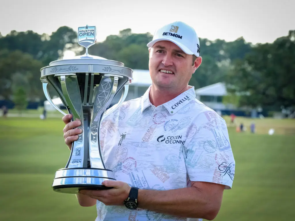 Jason Kokrak holds the trophy on the 18th green.  (Photo by F. Carter Smith)