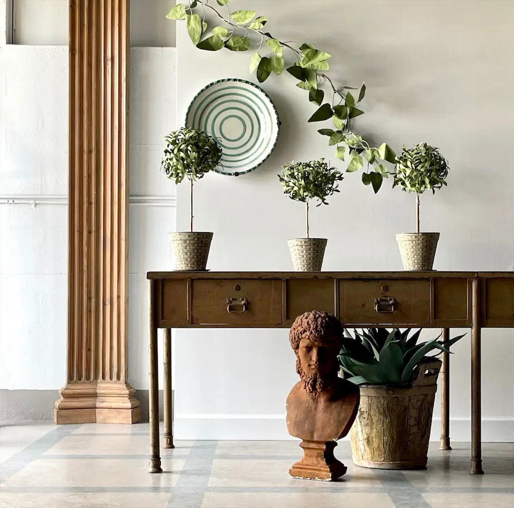 Vignette with an antique architectural column, bust, and buffet. (Photo by Charles Peed/Casa Gusto)