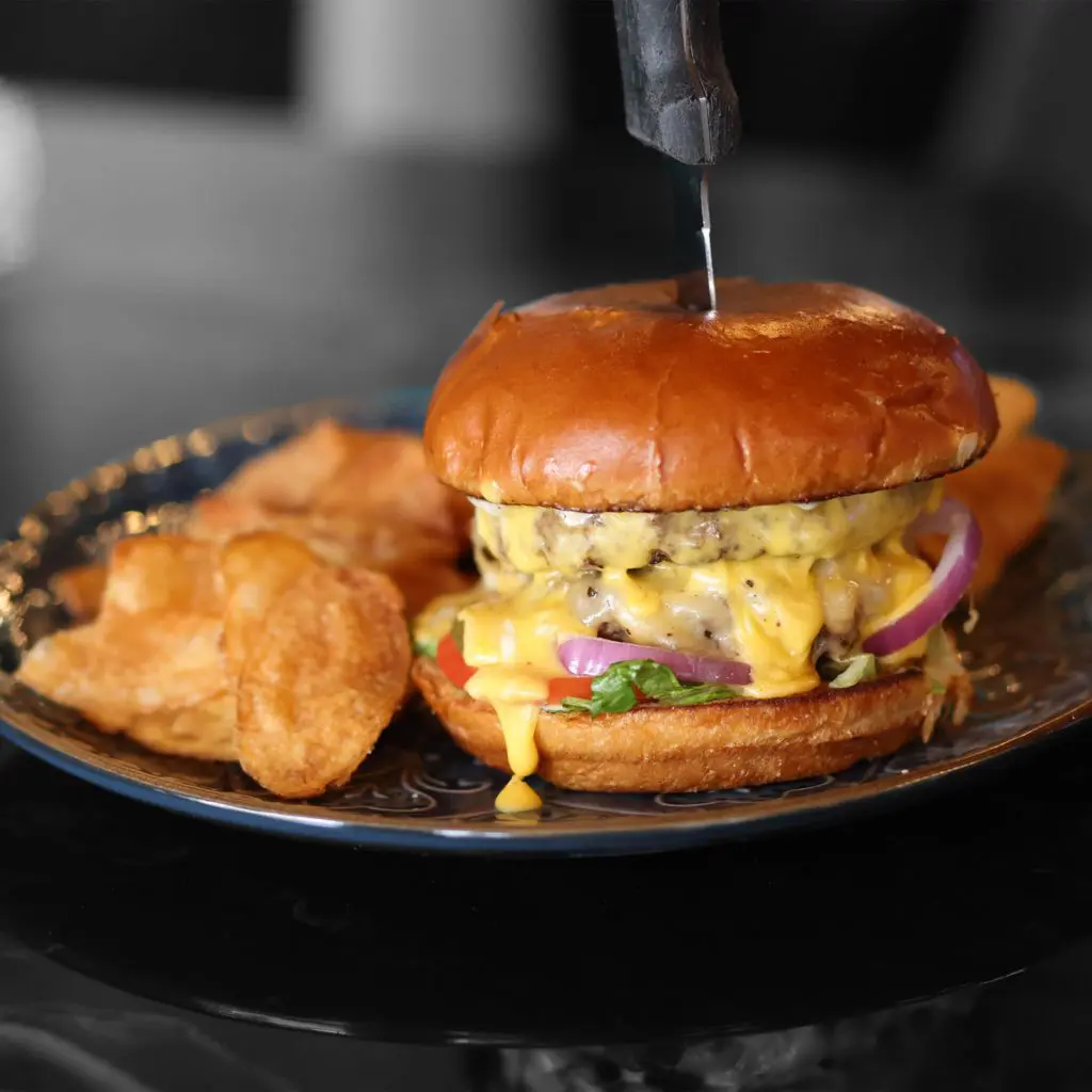 The Big D Burger at Chet's includes a double beef patty, Irish cheddar, Killian's cheese sauce, and peppercorn mayo. (Courtesy)