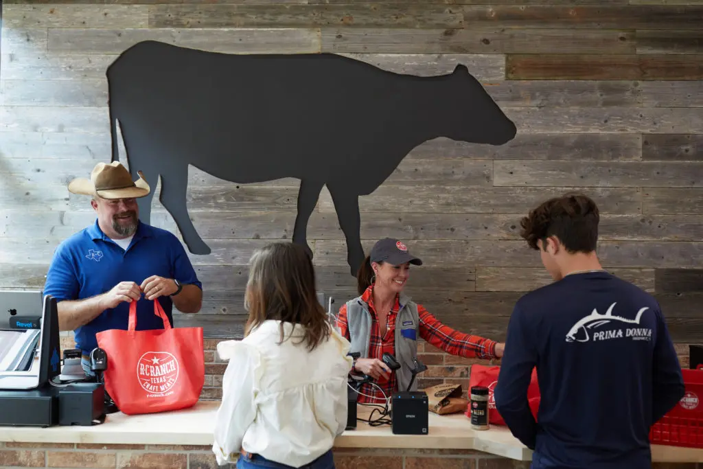 Co-founder Ryan Cade helps his customers at the new R-C Ranch at the historic Houston Farmer's Market. (Photo Jody Horton)
