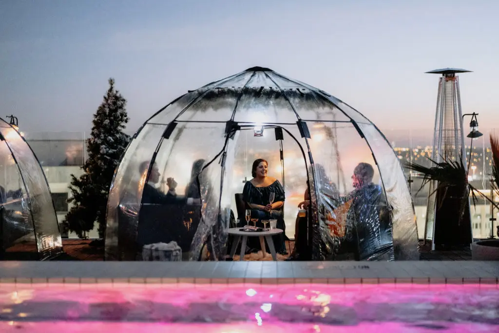 Enjoy a cocktail with friends this holiday season under a waterproof igloo. 