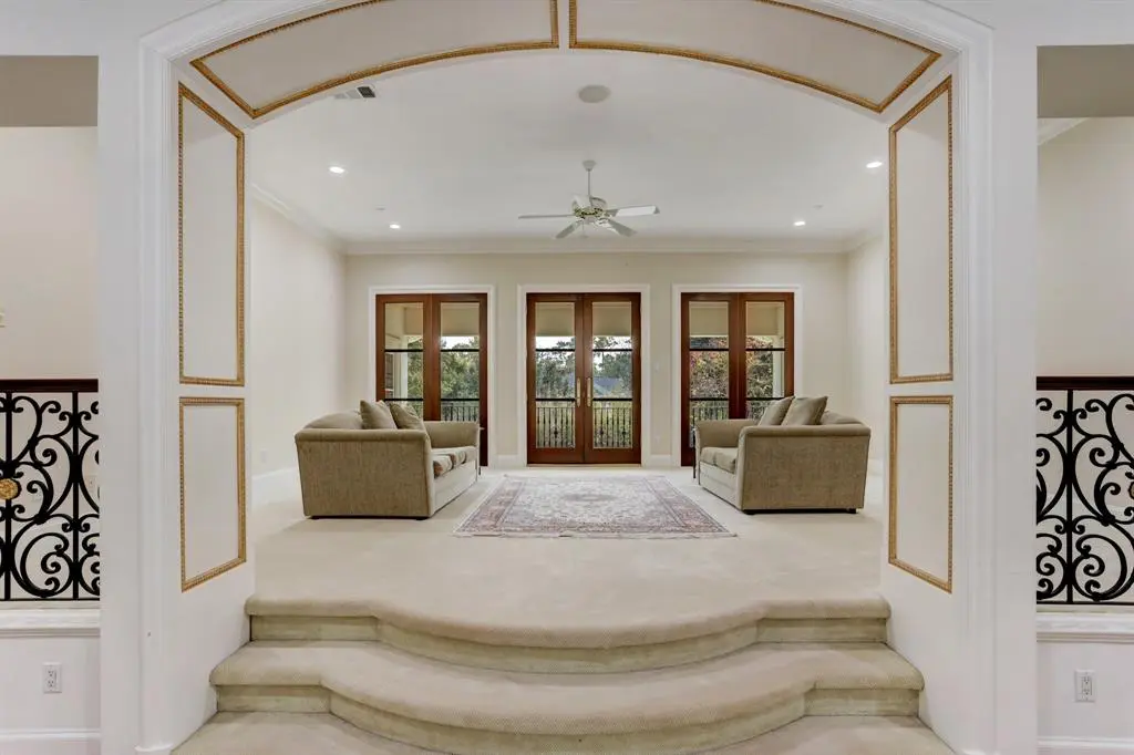 The second floor family room opens to the two story grand entry hall as well as the backyard terrace at 6 Pine Tree Lane. (Photo by TK Images)