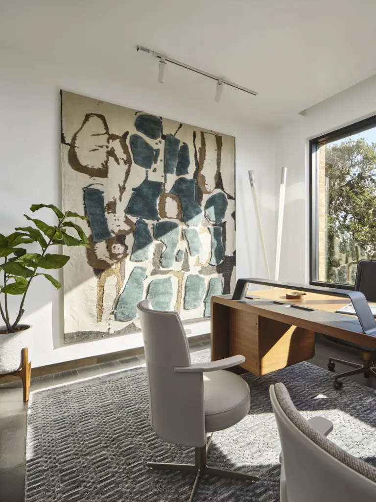 The office is a combination of high design with functionality with a large handmade tapestry to add art while absorbing sound.  A Viabizzuno floor lamp was added for a modern touch. Desk, office chair and tapestry by Giorgetti, side chairs by Poltrona Frau. (Photography
by Andrea Calo)