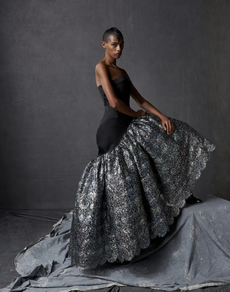 Bach Mai black silk satin cuir strapless column gown with silver crystal holofoil corded lace sculptured volant.(Photo by Dimitri Hyacinthe)