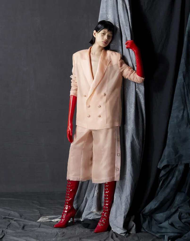Bach Mai blush silk organza double breasted tailored jacket with silk satin organza revers and chiffon lining, tearaway pants with silk satin organza plackets, silk chiffon lining, and rose gold ring snaps. (Photo by Dimitri Hyacinthe)