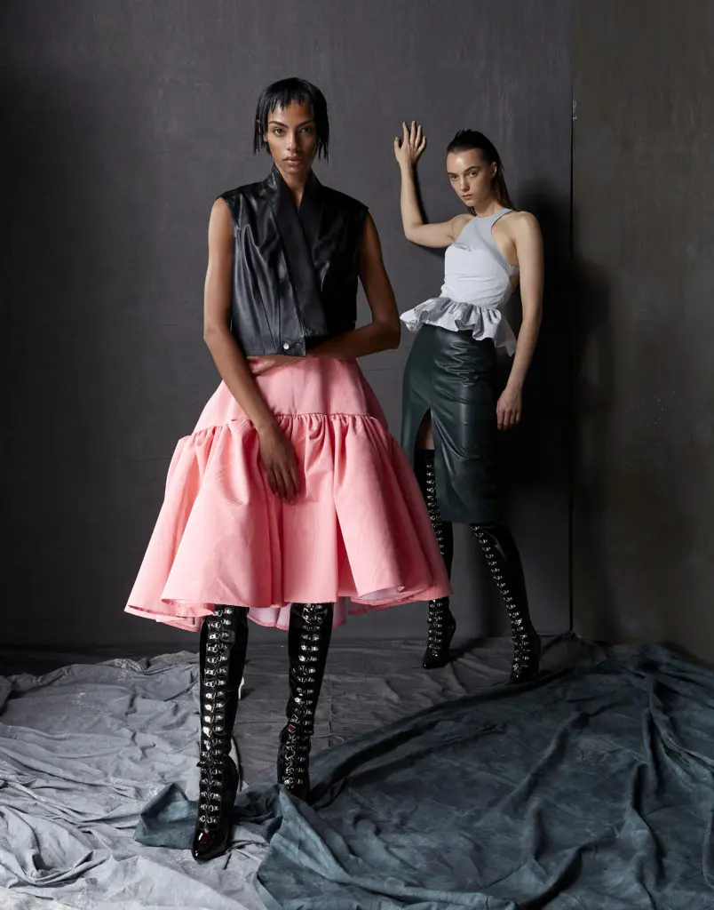 Bach Mai Napa leather sculpted back gilet with band collar and rococo pink moiré volant skirt, frost gray leather and moiré racerback halter peplum top with evergreen Napa leather front-slit pencil skirt . (Photo by Dimitri Hyacinthe)