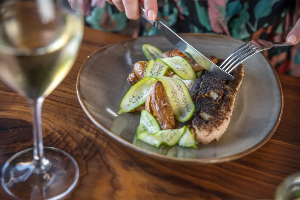 Chef Jonathan Lestingi's blackened redfish served with a Greek inspired sauce and fingerling potatoes. (Photo by Photos Care of Back Table Kitchen & Bar)