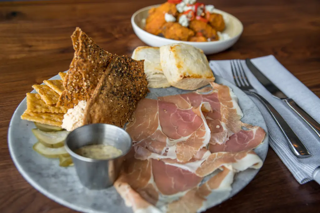 A signature dish: the ham and pimento cheese board served with beer mustard, pickles and warm biscuits. (Photo by Photos Care of Back Table Kitchen & Bar)