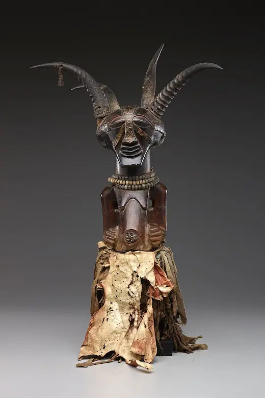 Four-Horn Community Power Figure made of Wood, pigment, copper, metal, glass beads, raffia, antelope horns, goat horn, and civet hide.