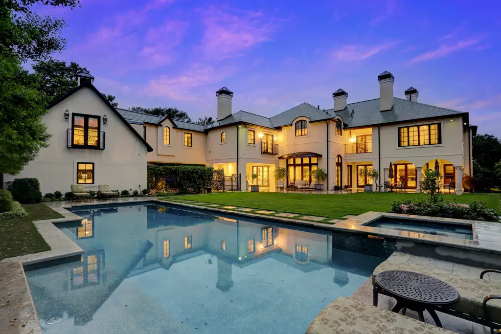 A view of this River Oaks estate at night. Resting on 25,000 square feet of manicured grounds, this property offers a private retreat.