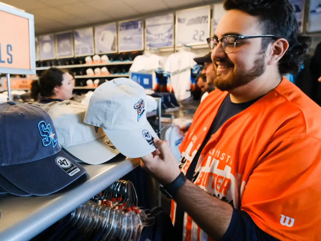 A baseball fan examines some of the new selections at the Sugar Land Space Cowboys' team store. (Photo by F. Carter Smith)